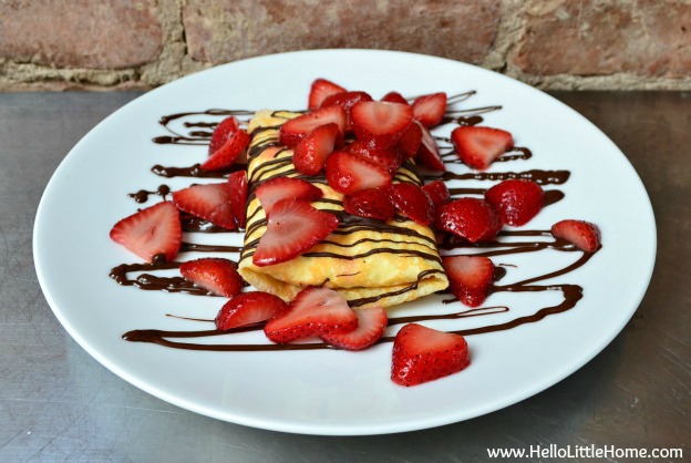 Strawberries and Cream Crepes with Chocolate Sauce ... Get this easy recipe + 100 other vegetarian winter recipes that are perfect for any occassion! | Hello Little Home