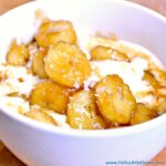A bowl of ice cream topped with salted caramelized bananas.