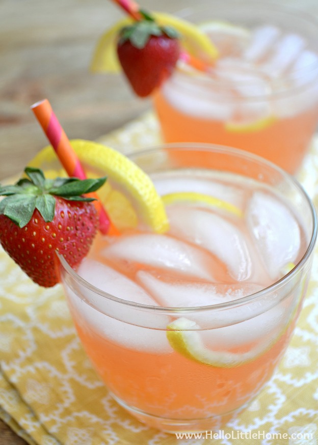 Two glasses of strawberry lemonade on a yellow napkin.