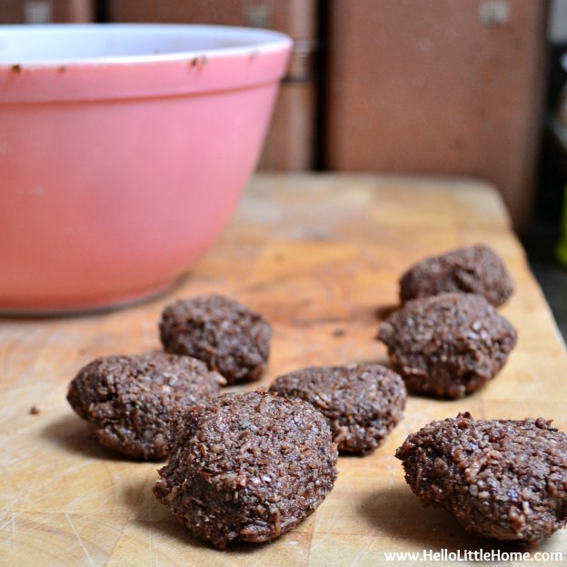 No Bake Chocolate Cookies on a cutting board with a mixing bowl in the background.