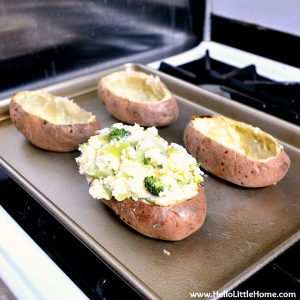 Stuffing potatoes with broccoli cheddar mixture.