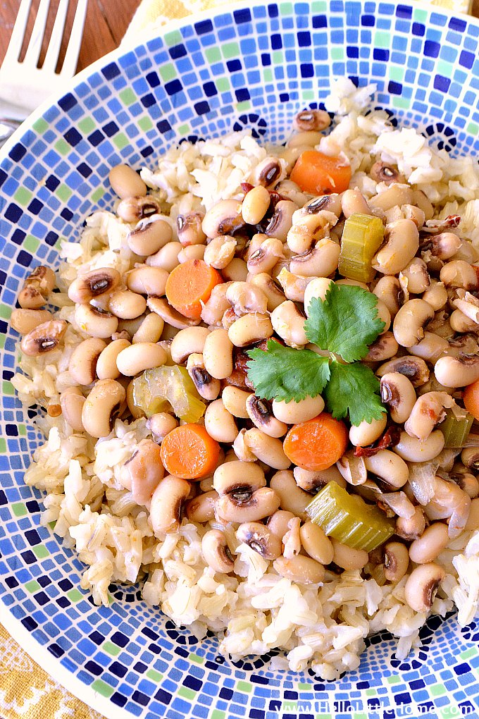 Closeup of vegetarian Black Eyed Peas in a Blue Bowl with a Yellow Napkin