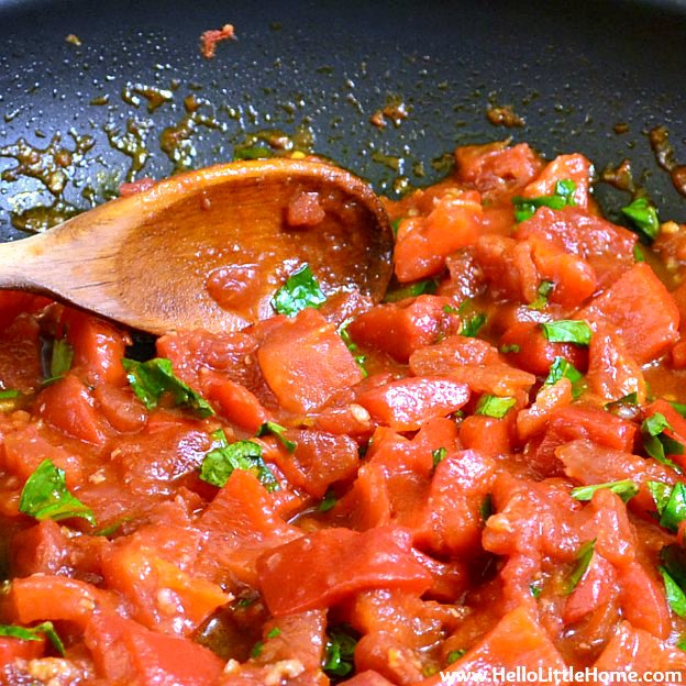 Making roasted red pepper sauce from scratch in a skillet.