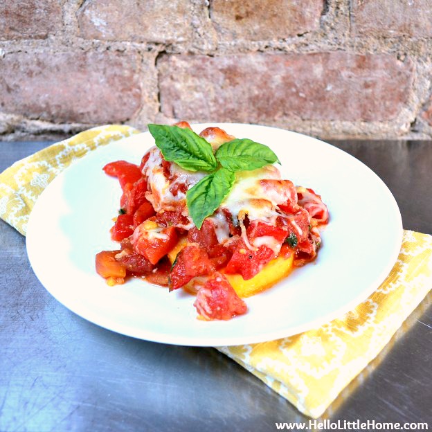 Homemade Roasted Red Pepper Sauce served over polenta and topped with basil.