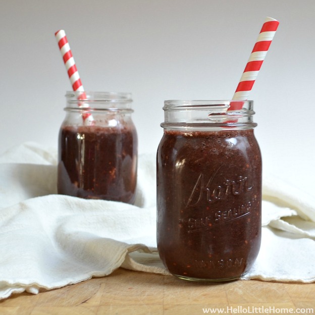 Two smoothies served in mason jars with striped straws.