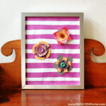 The finished spring paper flower craft displayed on a wood table.