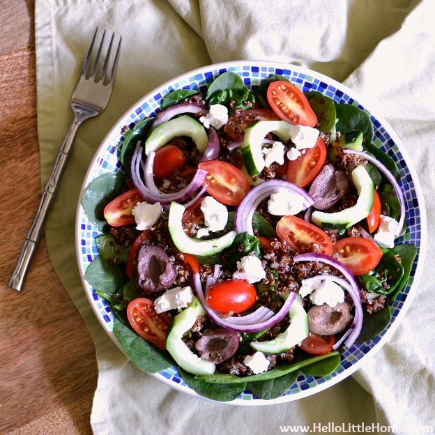 A bowl of Greek Quinoa Salad with Cucumbers, Tomatoes, Onions, Olives, and Feta