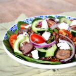 Healthy Greek Quinoa Salad with Veggies, Feta, and Greek Salad Dressing.