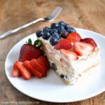 Red, White, and Blue Icebox Cake ... a delicious no bake dessert that's perfect for any patriotic get together, like the 4th of July! This easy, no bake icebox cake recipe is packed with fresh strawberries and blueberries, layered with a light lemon cheesecake and graham crackers. The perfect summer treat! | Hello Little Home