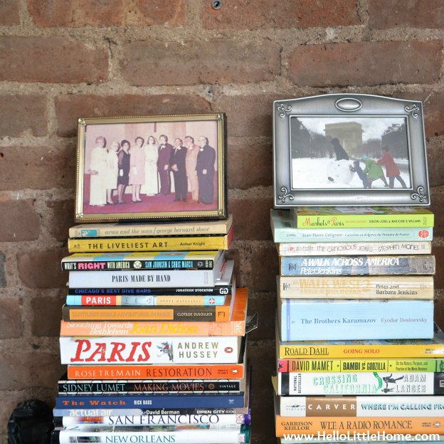 Stacks of books with framed photos on top.