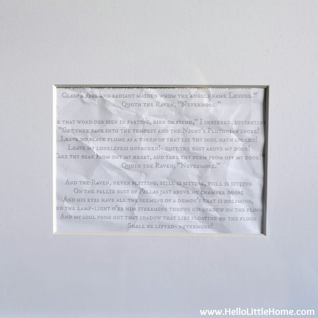 Closeup of the printable "The Raven" poem in a frame.