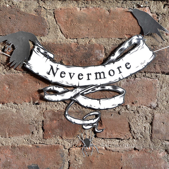 The Raven Halloween Decor hanging on a brick wall.