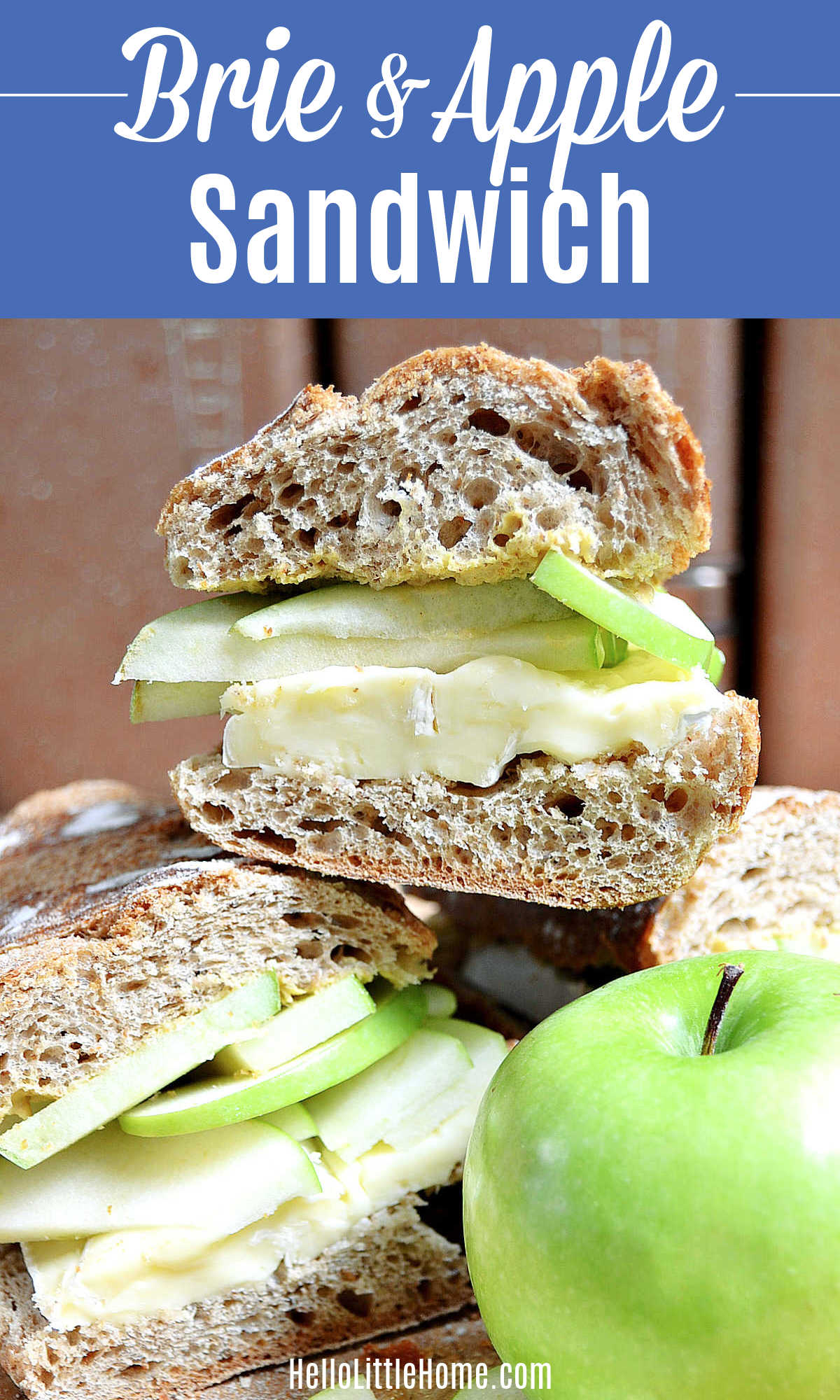 A stack of Brie Apple Sandwiches next to a green apple.