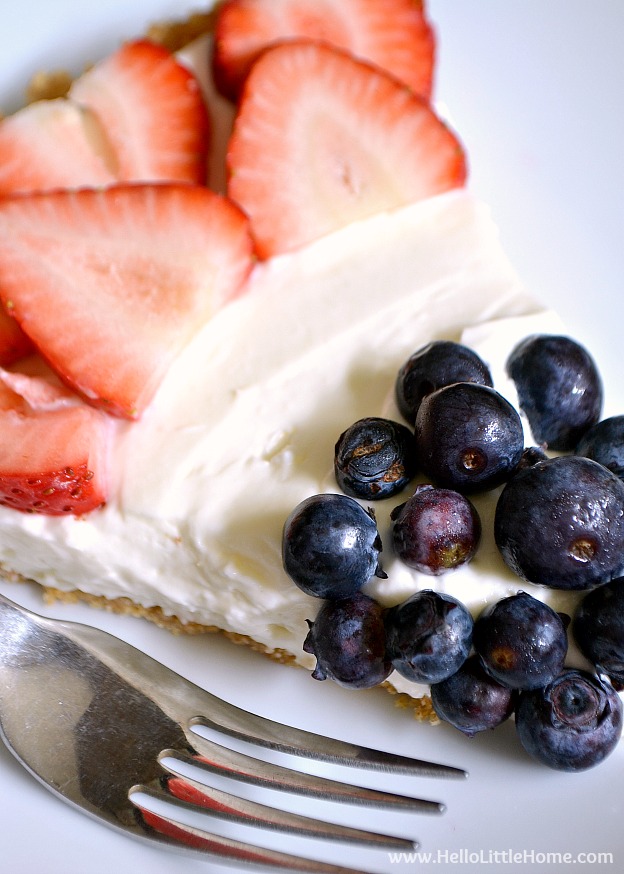 No Bake Red, White, and Blue Cheesecake Tart ... perfect for every summer party! This easy no bake cheesecake recipe is lightly flavored with lemon, made with a simple graham cracker crust, and topped with fresh strawberries and blueberries. An easy patriotic dessert recipe that's perfect for any summer holiday, like 4th of July and Memorial Day! | Hello Little Home