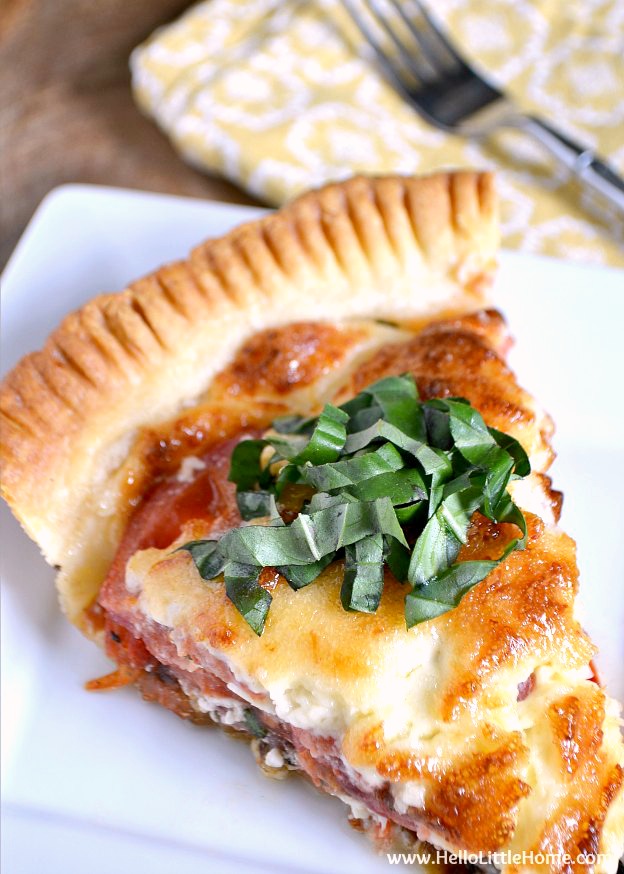 This Savory Tomato, Feta, and Basil Pie is a delicious twist on the Southern classic! Bursting with fresh summer flavors, you'll want to enjoy this classic tomato pie all season long! | Hello Little Home