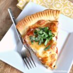 This Savory Tomato, Feta, and Basil Pie is a delicious twist on the Southern classic! Bursting with fresh summer flavors, you'll want to enjoy this classic tomato pie all season long! | Hello Little Home