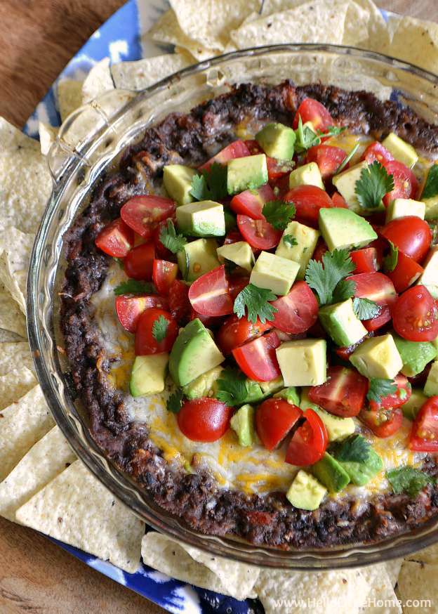 A bowl of Black Bean Dip surrounded by tortilla chips.