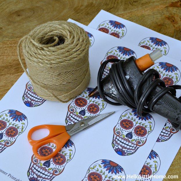 Supplies for the Day of the Dead banner arranged on a wood table.