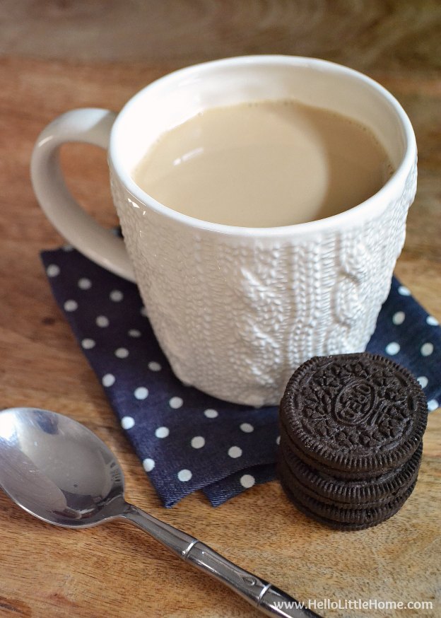 A mug of Sweet Cinnamon Milk Tea with a stack of oreos in front of it.
