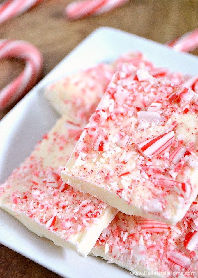 A plate of homemade bark with candy canes in the background.
