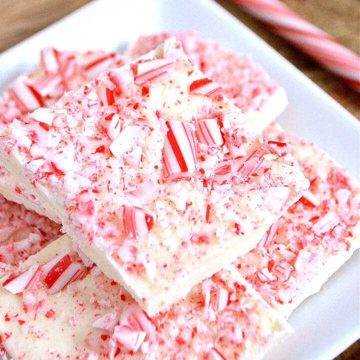 A white plate topped with pieces of White Chocolate Peppermint Bark.