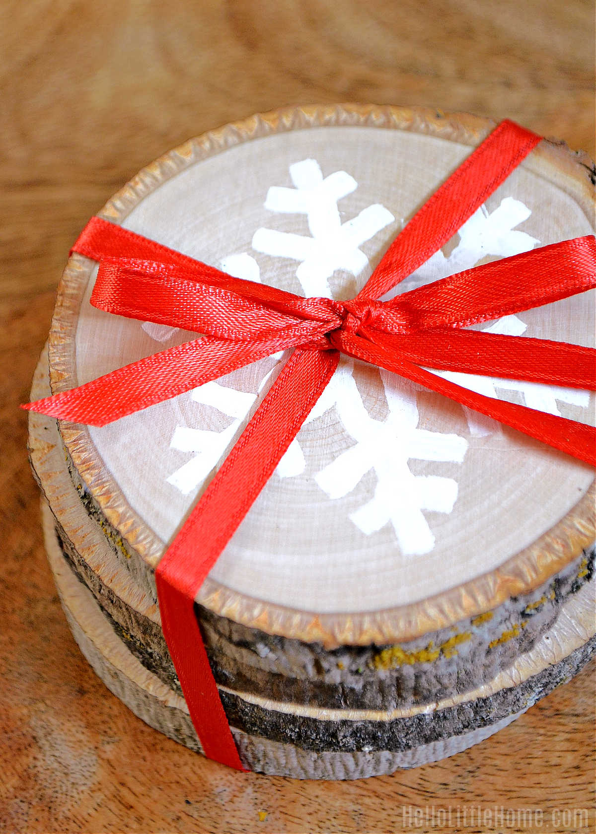 A stack of wood slice coasters tied together with ribbon.
