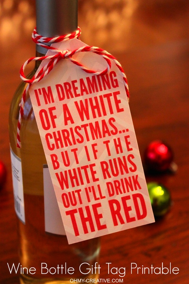 A red and white gift tag tied to a wine bottle.