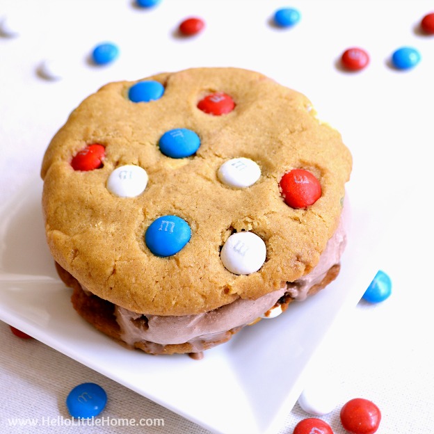 Peanut Butter Chocolate Ice Cream Sandwiches recipe ... a yummy red, white, and blue dessert that's perfect for summer! Homemade ice cream sandwiches are made from giant peanut butter cookies filled with M&M's and surrounding rich chocolate ice cream. These DIY ice cream sandwiches are perfect for any summer party! | Hello Little Home