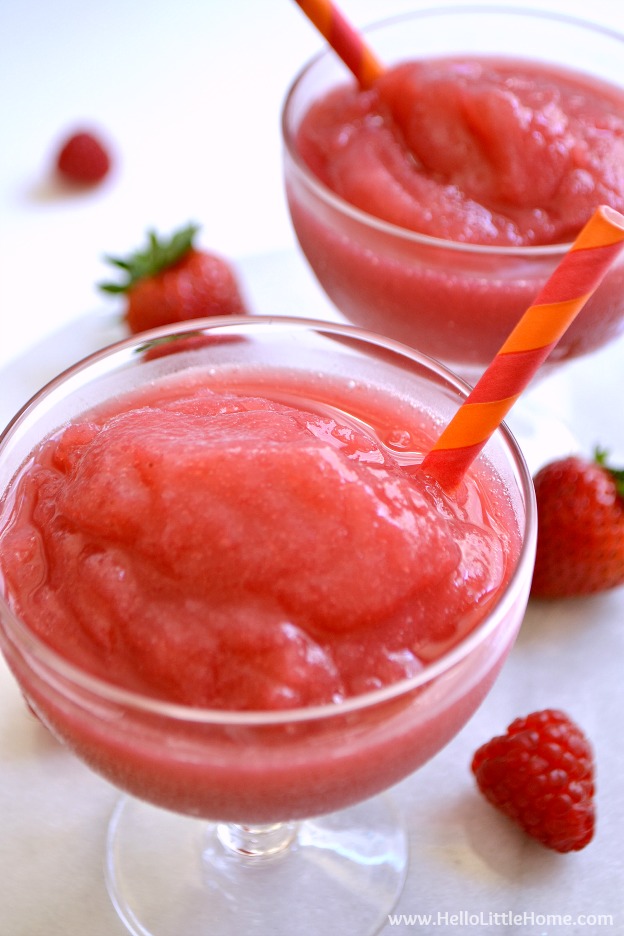 Frosé aka Frozen Strawberry Rosé Slushie ... the perfect summer cocktail recipe! Learn how to make this easy wine slushie recipe from your fave rosé wine, strawberries, and raspberries! This simple homemade frosé recipe comes together quickly in your ice cream maker or freezer. A delicious wine slush that's great for girl's night, birthdays, summer parties, or just because! | Hello Little Home