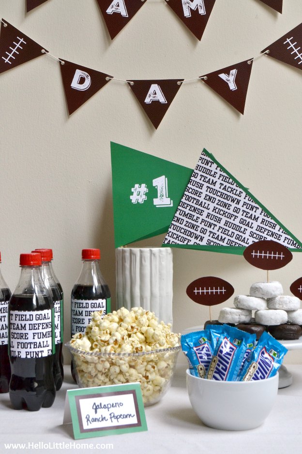 A table topped with snacks decorated for a football party.