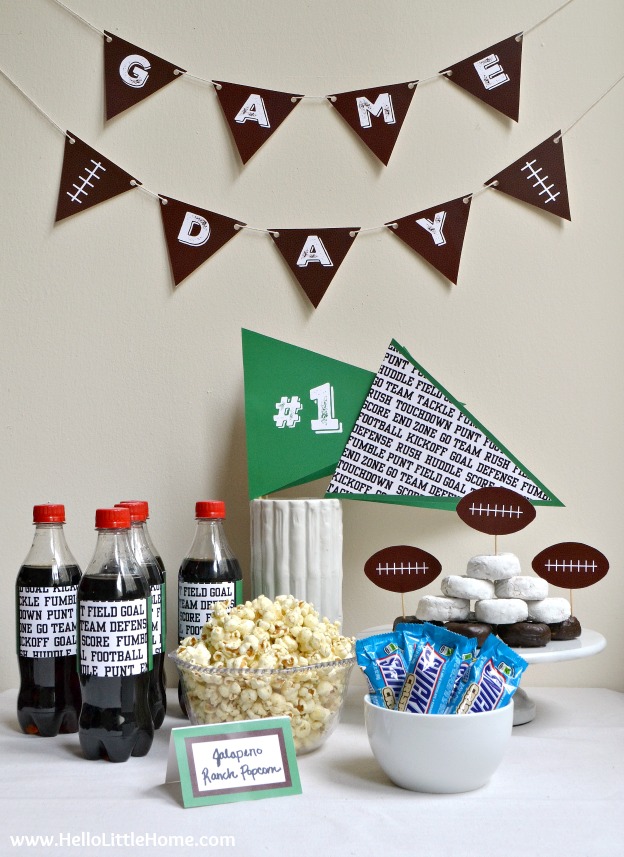 A table with snacks decorated for a football viewing party.