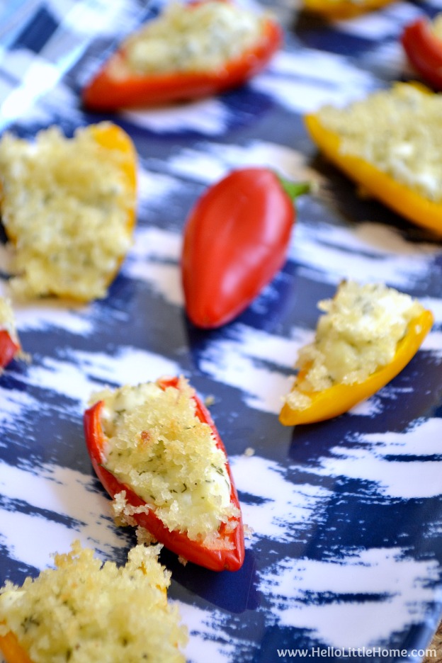 A patterned tray topped with stuffed mini peppers.