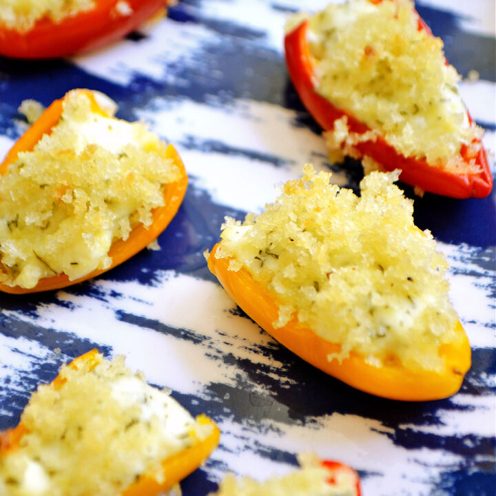 Feta Stuffed Peppers served on a patterned tray.