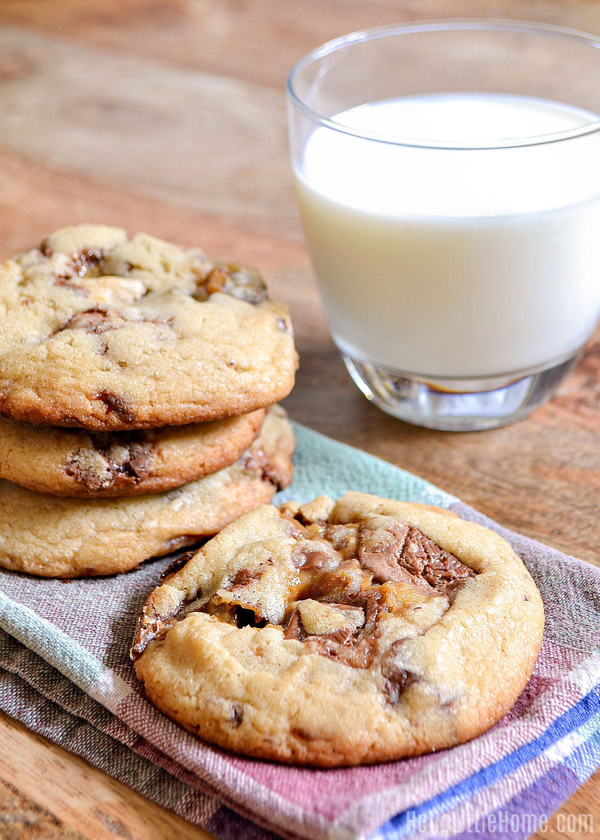 Stacks of Halloween Candy Cookies next to a glass of milk.