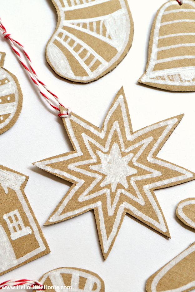 DIY Cardboard Gingerbread Ornaments ... make your own Christmas ornaments with this fun, easy, and CHEAP tutorial! These DIY Christmas ornaments are a great holiday craft for kids and for adults that’s made from paper. Use these simple DIY Christmas ornaments for your tree, for gift decorating, or give them as a holiday present! | Hello Little Home