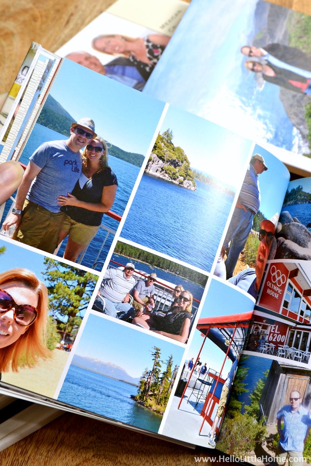 A hand opening a family yearbook to a page with a grid of colorful photos.