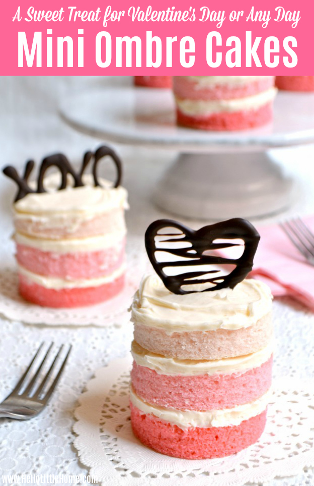 A Mini Ombre Cake topped with a chocolate heart, with more cakes in the background.