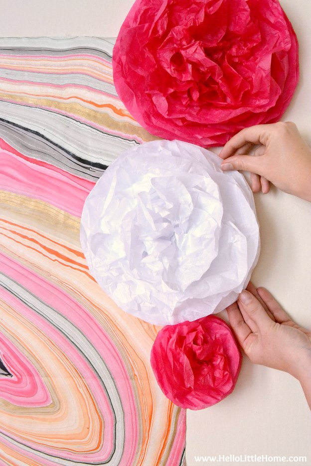 DIY Tissue Paper Pom Poms ... a cute decoration that's perfect for any party! Follow this easy tutorial and learn how to make DIY tissue paper pom poms in any size or color ... perfect for birthday parties, weddings, bridal showers, or any special occasion! | Hello Little Home