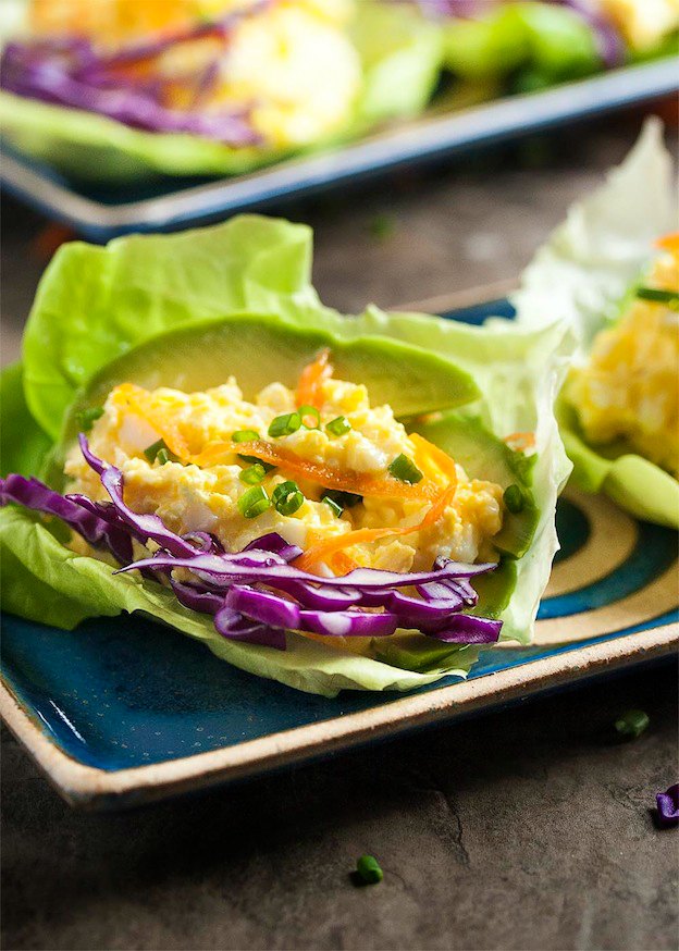 A plate topped with an egg salad lettuce wrap.