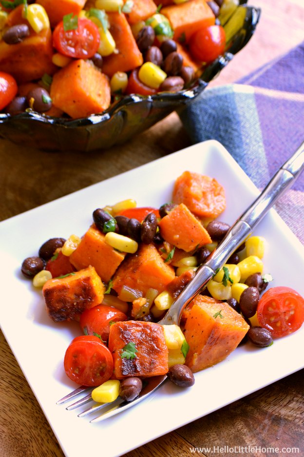 Tex Mex Roasted Sweet Potato Salad ... a delicious vegetarian side dish recipe your family will love! This cold roasted sweet potato salad is packed with healthy, fresh ingredients: black beans, corn, tomatoes, and cilantro ... all tossed together with an amazing chili lime vinaigrette (with a touch of maple syrup). It's also gluten free and vegan, and makes a tasty side or even a light dinner or lunch! | Hello Little Home