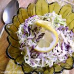 Greek Coleslaw recipe with Feta and Lemon ... a delicious side dish for any summer meal or BBQ! This easy slaw recipe features a tangy greek yogurt dressing bursting with feta and lemon flavors. A healthy, gluten free slaw recipe your whole family will love! | Hello Little Home