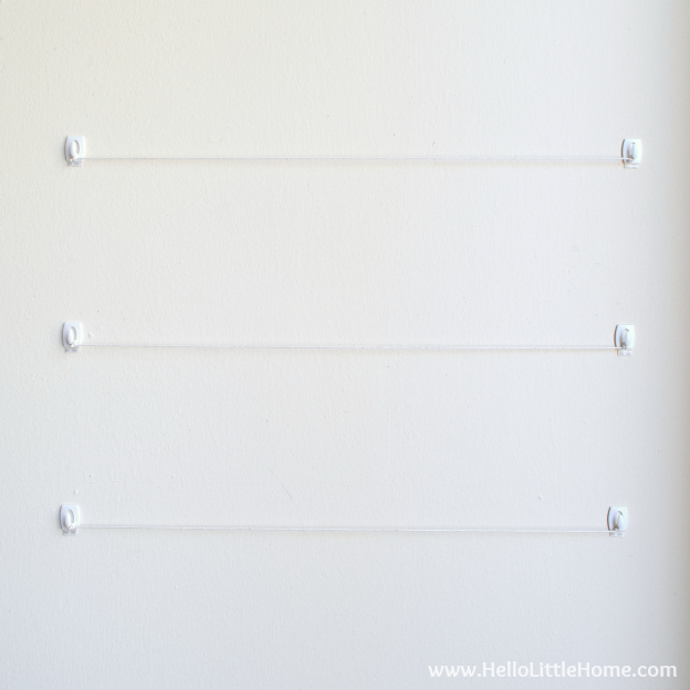 Cheap + easy DIY Photo Display! Looking for easy photography display ideas? Learn how to make this simple wall system with clothespins, twine, and command hooks! A fast + fun photo display tutorial that's perfect for apartments, dorm rooms, weddings, offices, or anywhere you don't want to damage walls! | Hello Little Home