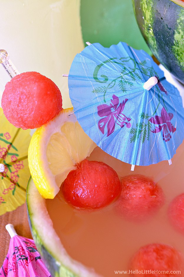 A bowl of Watermelon Punch garnished with an umbrella.