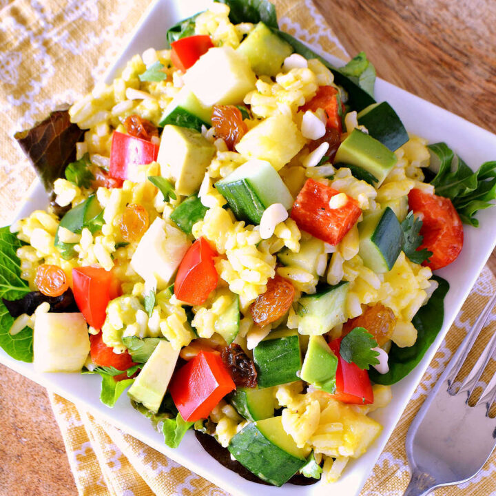 A plate of Tropical Rice Salad served on a yellow napkin.