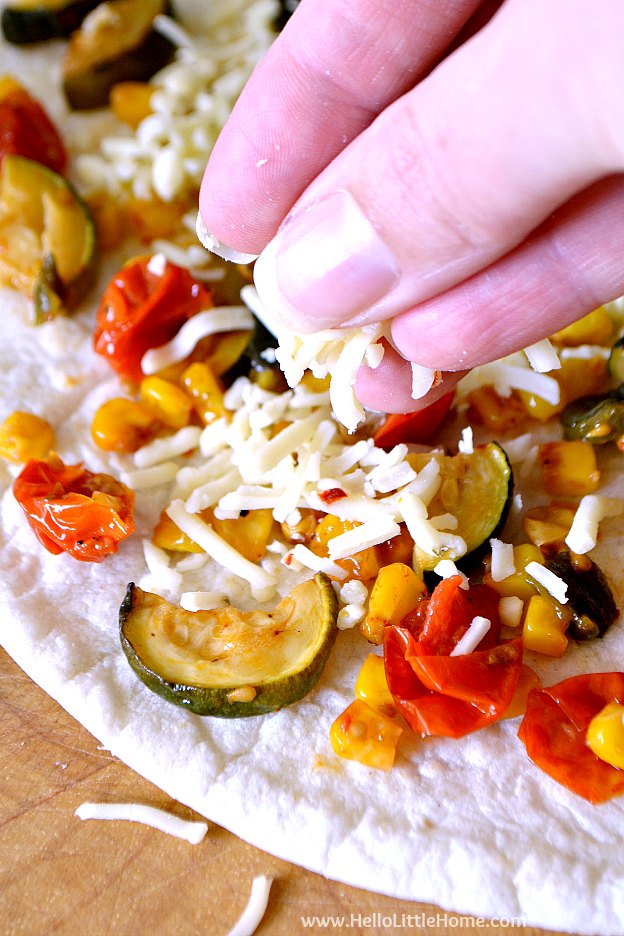 Easy Roasted Vegetable Quesadillas recipe! Learn how to make this delicious veggie quesadilla recipe featuring crispy flour tortillas packed with cheese and roasted zucchini, tomatoes, corn, and poblano peppers. Serve these vegetarian quesadillas with salsa and sour cream for a simple meatless Mexican lunch, dinner, or snack! | Hello Little Home