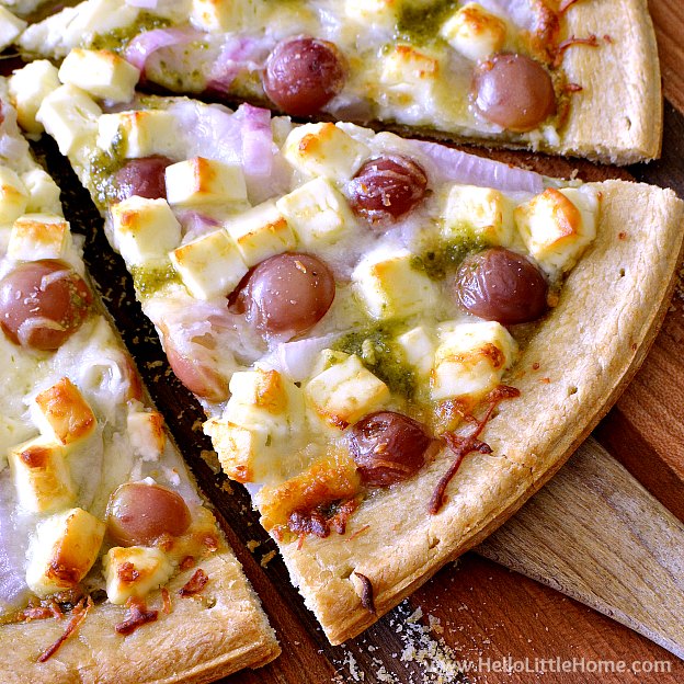 Grape, Feta, and Pesto Pizza recipe! Treat yourself to a simple, yet creative pizza ... this homemade vegetarian pesto pizza recipe is packed with flavor and yummy ingredients. It's the perfect balance of sweet and salty flavors! | Hello Little Home