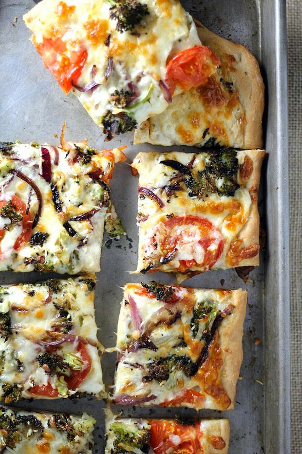 Slices of Roasted Vegetable Alfredo Pizza on a baking sheet.