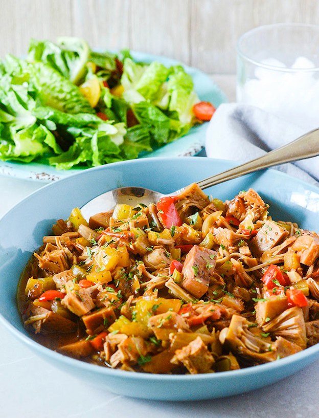 A bowl of jackfruit stew served with a salad.