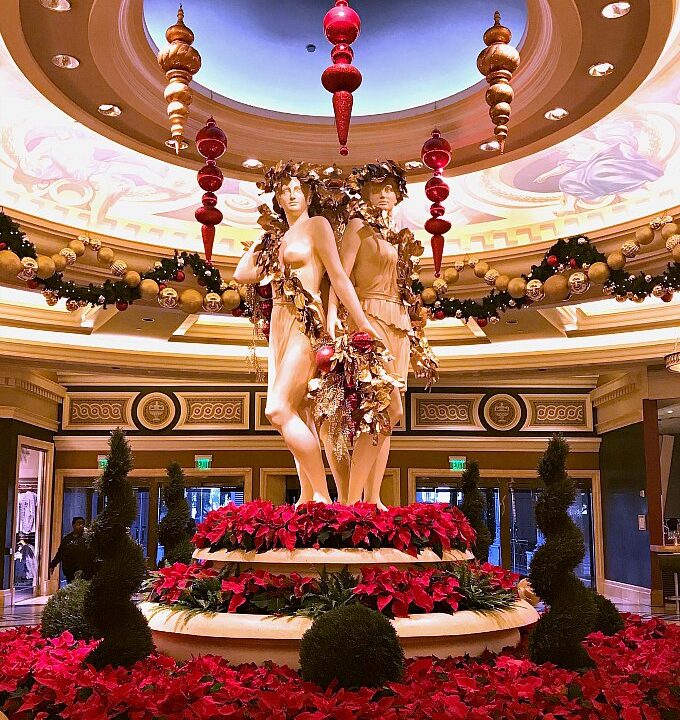 Statues in Caesar's Palace Surrounded by Poinsettias and Christmas Ornaments