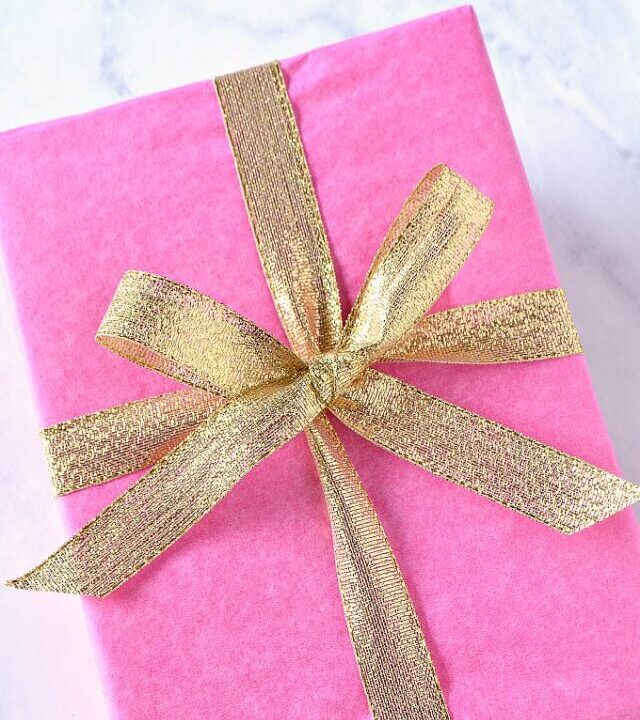 A pink present with a gold bow.